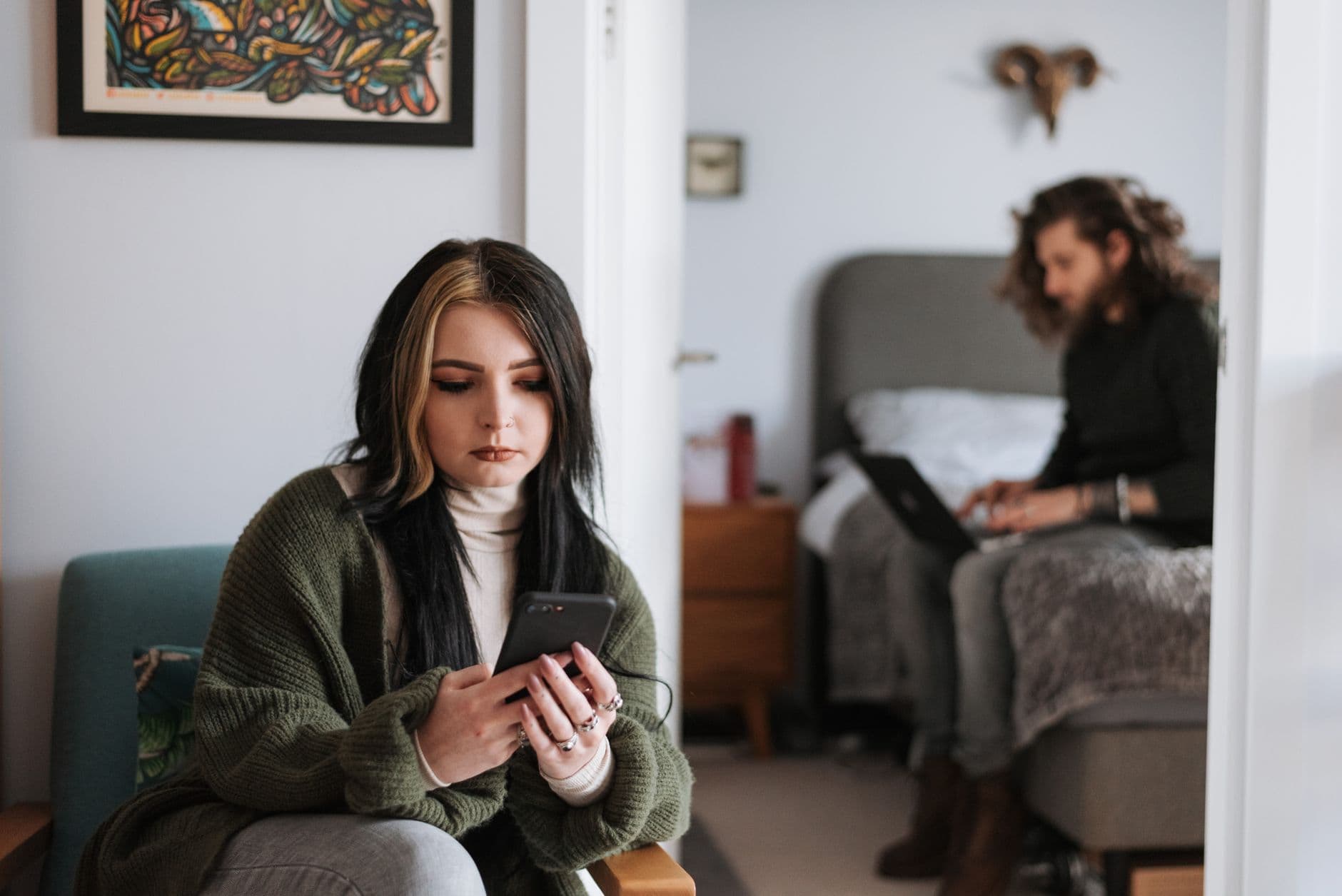 Person hiding phone screen suggesting cheating